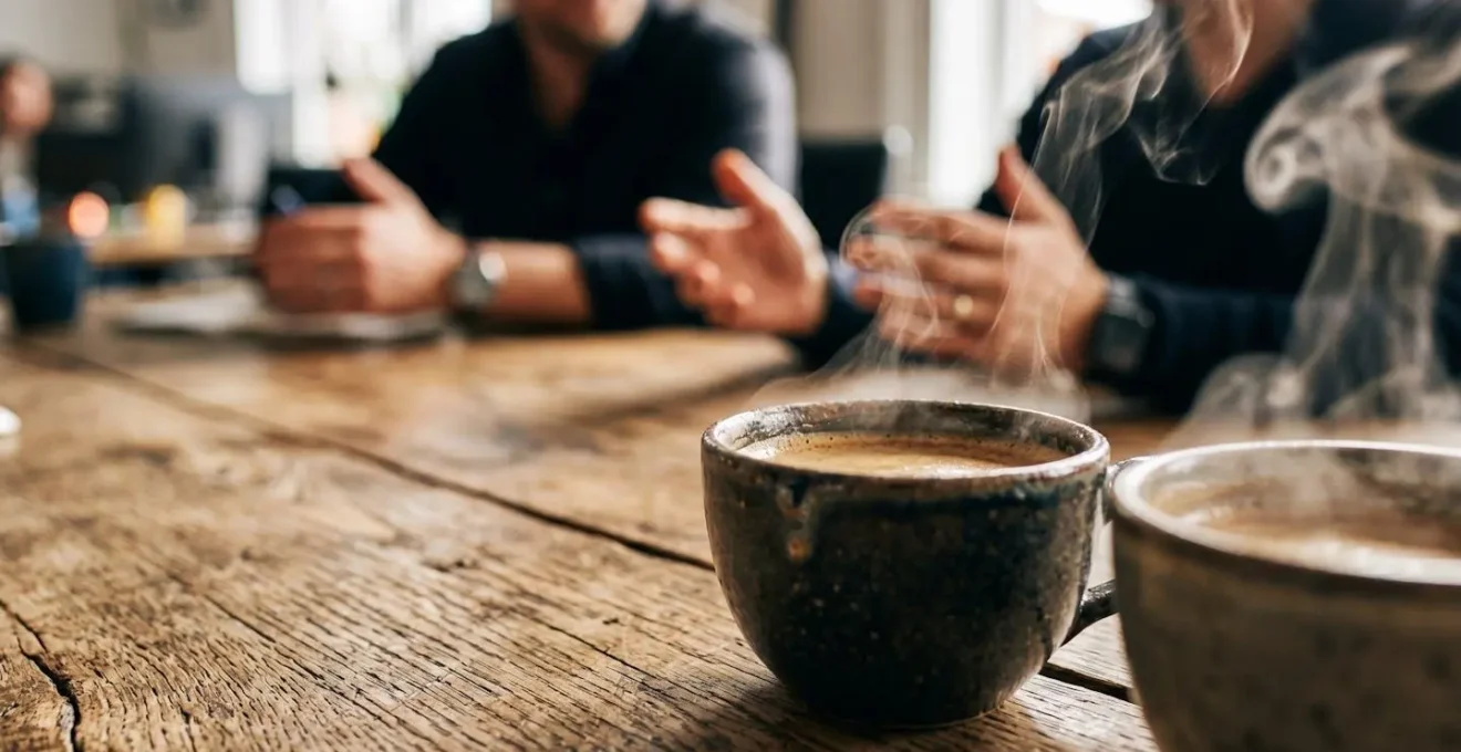 Informal coffee meeting between finance professionals building workplace alliances