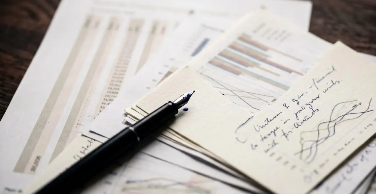Extreme close-up of financial documents and handwritten notes, symbolizing deep interview preparation.